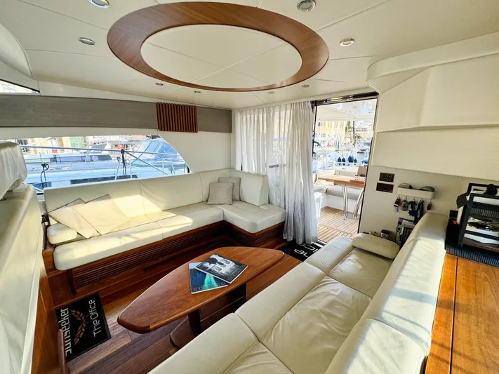 The Office Yacht Photos Pics Luxurious interior of a 2015 Sunseeker Manhattan 55 yacht with elegant seating and wooden accents.