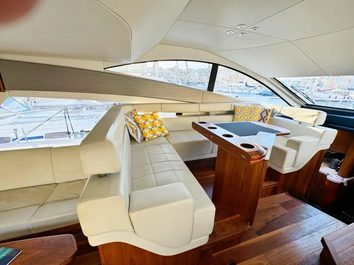 The Office Yacht Photos Pics Luxurious interior of 2015 Sunseeker Manhattan 55 yacht with elegant seating and wooden table.