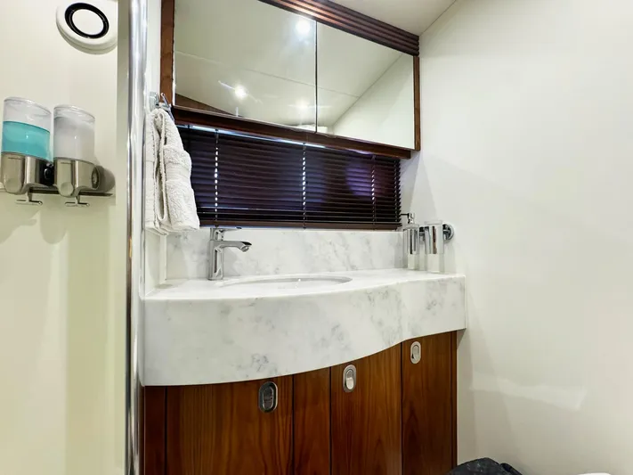The Office Yacht Photos Pics Luxurious bathroom in 2015 Sunseeker Manhattan 55 yacht with marble sink and wooden cabinets.