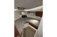 Interior cabin of 2023 Nimbus 305 Coupe with cozy bedding and modern design.