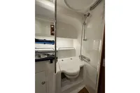 Modern bathroom in 2023 Nimbus 305 Coupe yacht with shower and sink.