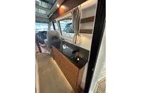 Interior of 2023 Nimbus 305 Coupe, featuring sleek cabinetry and modern design elements.