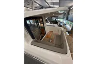 2023 Nimbus 305 Coupe interior with seating and table, showcasing modern design.