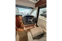 Interior of 2023 Nimbus 305 Coupe, featuring modern helm and comfortable seating.