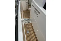 2023 Nimbus 305 Coupe boat deck with teak flooring and stainless steel details.