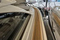 2023 Nimbus 305 Coupe yacht with sleek design and wooden deck details.