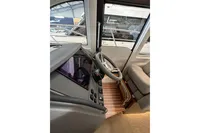 Interior view of 2023 Nimbus 305 Coupe cockpit with steering wheel and controls.