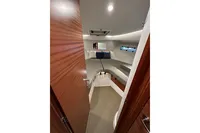 Cozy cabin interior of 2023 Nimbus 305 Coupe with modern design and comfortable bedding.