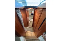 Interior view of 2023 Nimbus 305 Coupe, featuring wooden cabinetry and cozy cabin space.