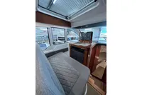Interior of 2023 Nimbus 305 Coupe, featuring modern seating and navigation equipment.