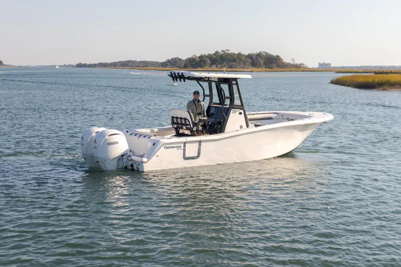 Yacht Photos Pics 2024 Tidewater 256 CC Adventure boat cruising on calm waters.