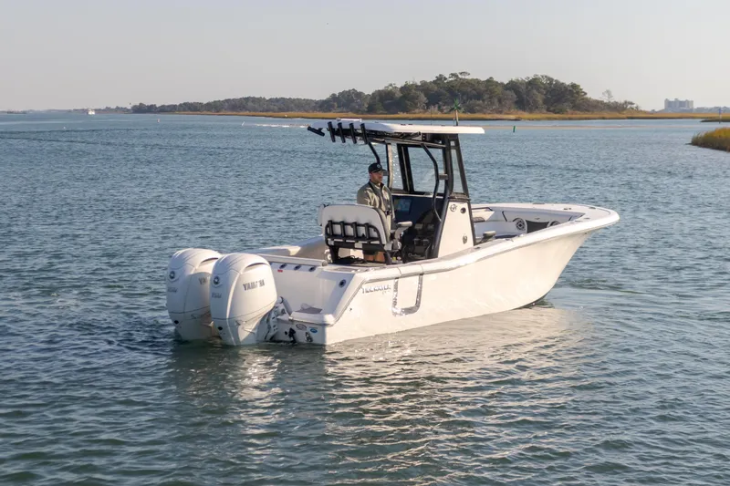  Yacht Photos Pics 2024 Tidewater 256 CC Adventure boat cruising on a calm lake.