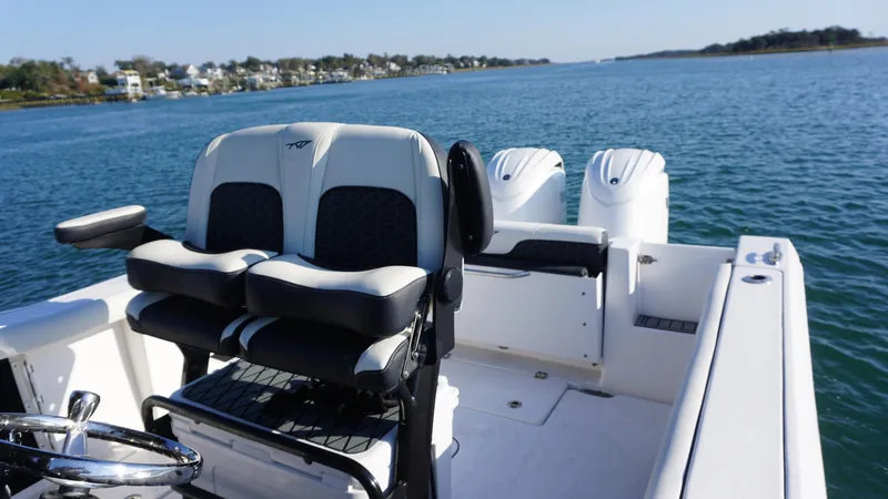  Yacht Photos Pics 2024 Tidewater 256 CC Adventure boat with dual engines on a scenic waterway.