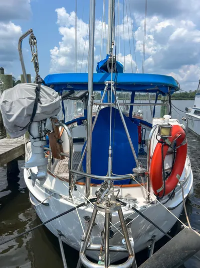 Della Therese Yacht Photos Pics 1986 Tayana Vancouver 42 sailboat docked, featuring blue canopy and life preserver.