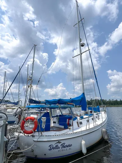 Della Therese Yacht Photos Pics 1986 Tayana Vancouver 42 sailboat docked under a cloudy sky.