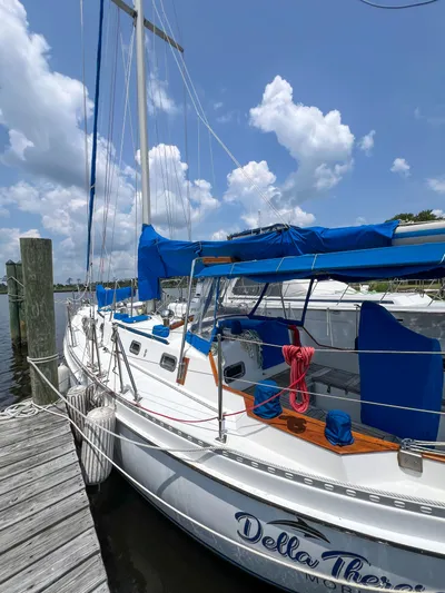Della Therese Yacht Photos Pics 1986 Tayana Vancouver 42 sailboat docked, featuring blue covers and clear sky background.