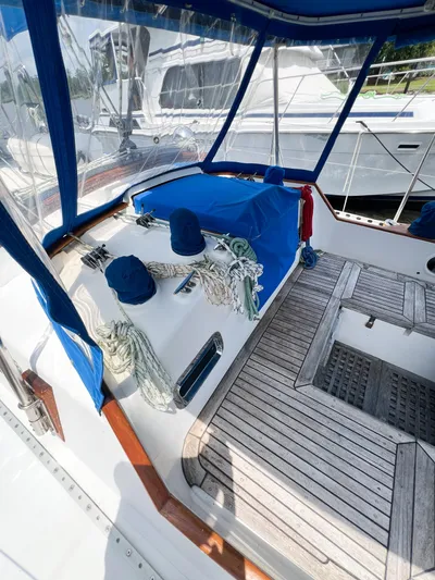 Della Therese Yacht Photos Pics Cockpit of 1986 Tayana Vancouver 42 sailboat with blue canvas and wooden deck.