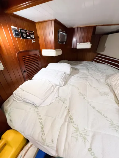 Della Therese Yacht Photos Pics Cozy cabin interior of 1986 Tayana Vancouver 42 sailboat with wooden paneling and bedding.
