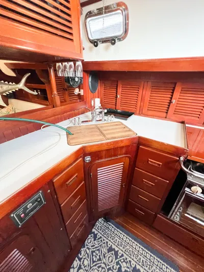 Della Therese Yacht Photos Pics 1986 Tayana Vancouver 42 yacht interior with wooden cabinetry and compact kitchen area.