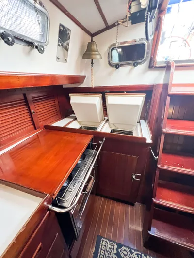 Della Therese Yacht Photos Pics Interior of 1986 Tayana Vancouver 42 sailboat galley with wood finish and appliances.