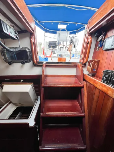 Della Therese Yacht Photos Pics Interior view of 1986 Tayana Vancouver 42 sailboat with wooden stairs and blue canopy.