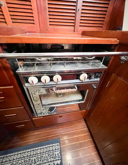 Della Therese Yacht Photos Pics Vintage stove in 1986 Tayana Vancouver 42 yacht kitchen with wooden cabinetry.