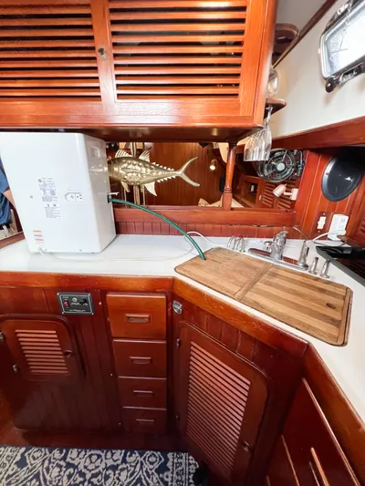 Della Therese Yacht Photos Pics 1986 Tayana Vancouver 42 yacht kitchen with wooden cabinetry and countertop.