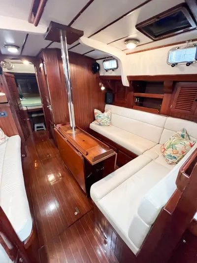 Della Therese Yacht Photos Pics Interior of 1986 Tayana Vancouver 42 yacht with wooden finish and white seating.