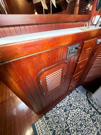 Della Therese Yacht Photos Pics Wooden interior of 1986 Tayana Vancouver 42 sailboat with cabinetry and patterned rug.