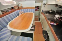 Interior of 2008 Trimaran POLYNESIA 42 with cozy seating and kitchen area.