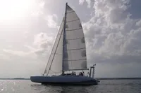 Trimaran POLYNESIA 42 sailing on calm waters under a cloudy sky, 2008 model.