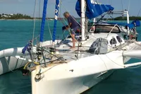 Trimaran POLYNESIA 42, 2008 model, sailing in clear turquoise waters.