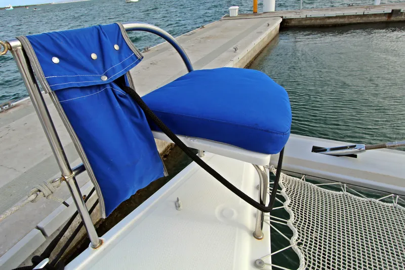  Yacht Photos Pics Blue cushioned seat on 2008 Fountaine Pajot Orana 44 catamaran, docked by the water.
