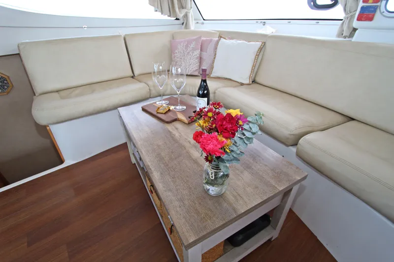  Yacht Photos Pics Luxurious interior of 2008 Fountaine Pajot Orana 44 with cozy seating and elegant decor.