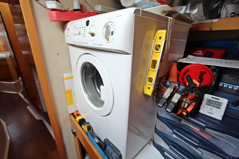  Yacht Photos Pics Laundry area on 2008 Fountaine Pajot Orana 44 catamaran with washing machine and tools.