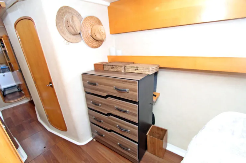  Yacht Photos Pics Interior of 2008 Fountaine Pajot Orana 44 with wooden drawers and hats on wall.