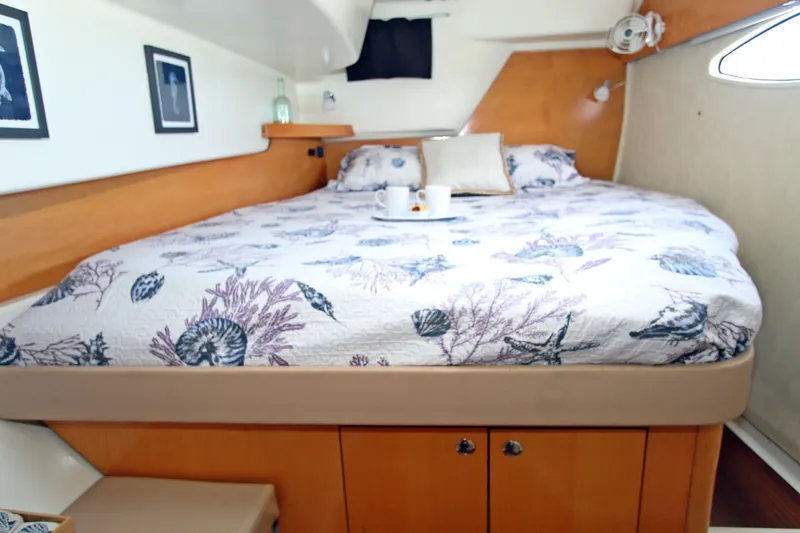  Yacht Photos Pics Cozy bedroom in 2008 Fountaine Pajot Orana 44 catamaran with nautical-themed bedding.