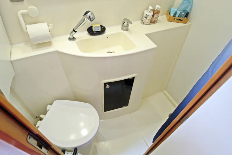 Yacht Photos Pics Compact bathroom in 2008 Fountaine Pajot Orana 44 catamaran, featuring sink and toilet.