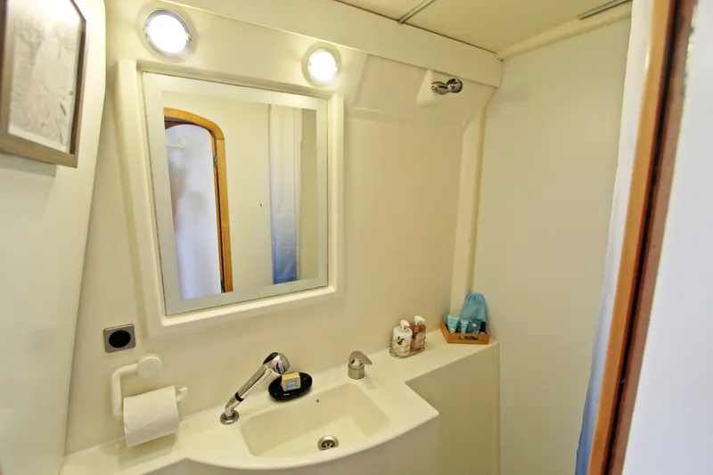  Yacht Photos Pics Bathroom interior of 2008 Fountaine Pajot Orana 44 catamaran, featuring sink and mirror.