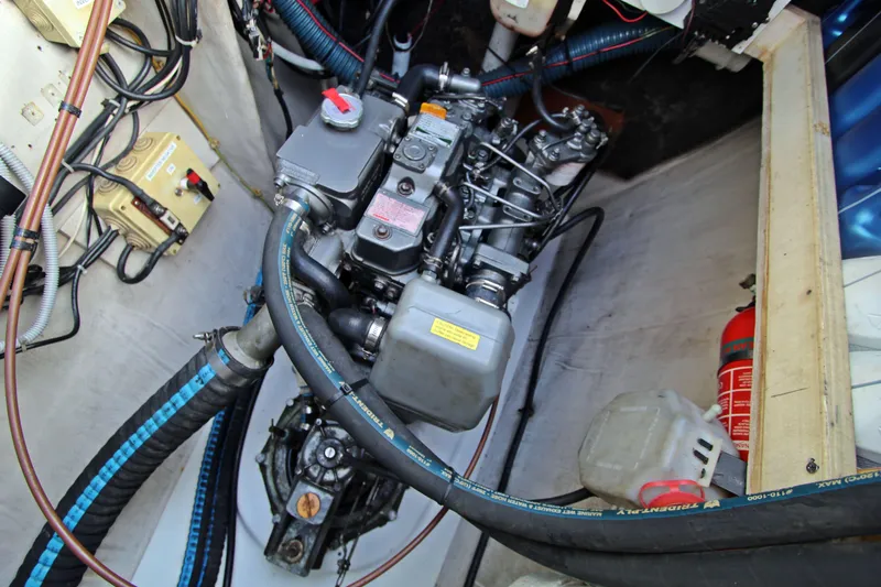  Yacht Photos Pics Engine compartment of 2008 Fountaine Pajot Orana 44 catamaran with visible hoses and fire extinguisher.