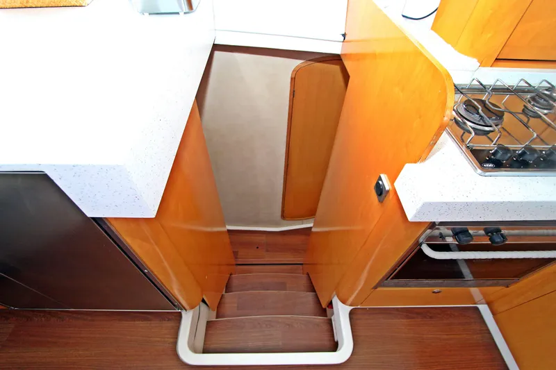  Yacht Photos Pics Interior of 2008 Fountaine Pajot Orana 44 yacht kitchen with stairs and stove.