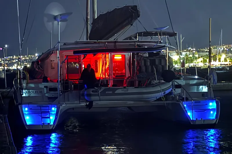  Yacht Photos Pics Fountaine Pajot Orana 44 catamaran, 2008 model, illuminated at night with blue and red lights.