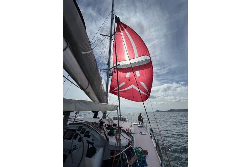 Yacht Photos Pics 2008 Fountaine Pajot Orana 44 sailing with vibrant red spinnaker on open sea.