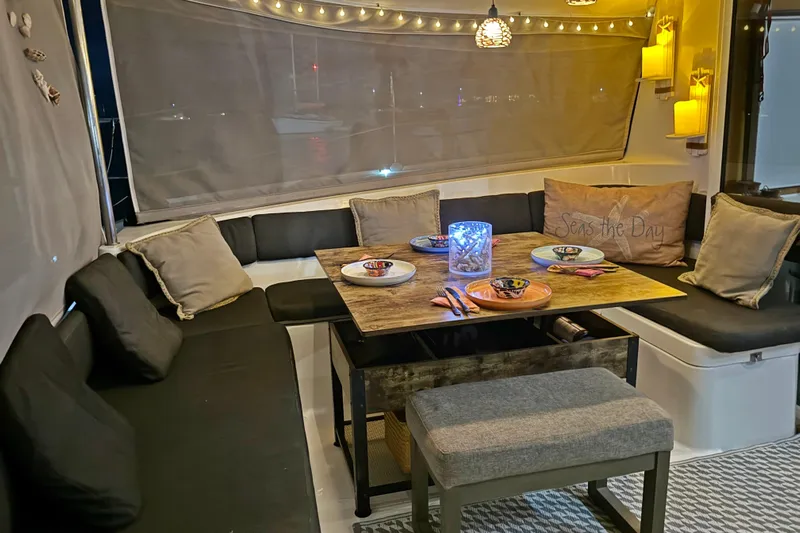 Yacht Photos Pics Cozy dining area on 2008 Fountaine Pajot Orana 44 catamaran with ambient lighting and nautical decor.