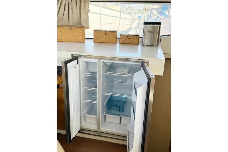  Yacht Photos Pics Open refrigerator in 2008 Fountaine Pajot Orana 44 yacht kitchen interior.