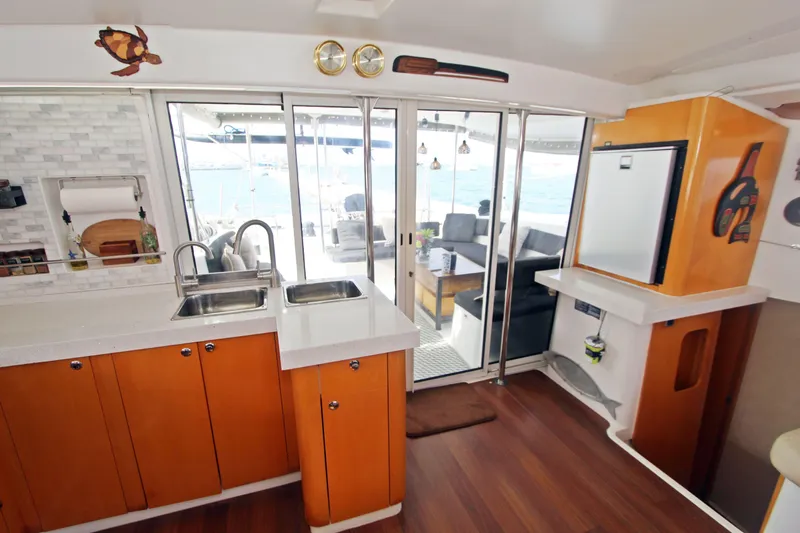  Yacht Photos Pics Interior of 2008 Fountaine Pajot Orana 44 catamaran with modern kitchen and outdoor seating area.