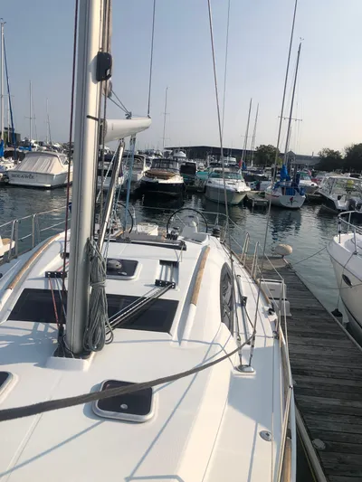 Superstition Yacht Photos Pics 2012 Beneteau Oceanis 40 sailboat docked in a marina, surrounded by other boats.