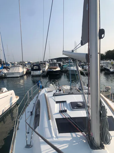 Superstition Yacht Photos Pics 2012 Beneteau Oceanis 40 sailboat docked in a marina, surrounded by other boats.