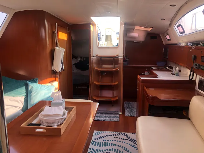 Superstition Yacht Photos Pics Interior of 2012 Beneteau Oceanis 40 sailboat with wood finish and cozy seating area.