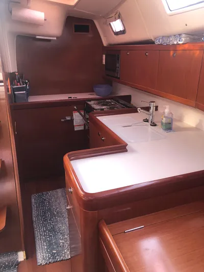 Superstition Yacht Photos Pics Interior of 2012 Beneteau Oceanis 40 sailboat kitchen with wood cabinetry and modern appliances.